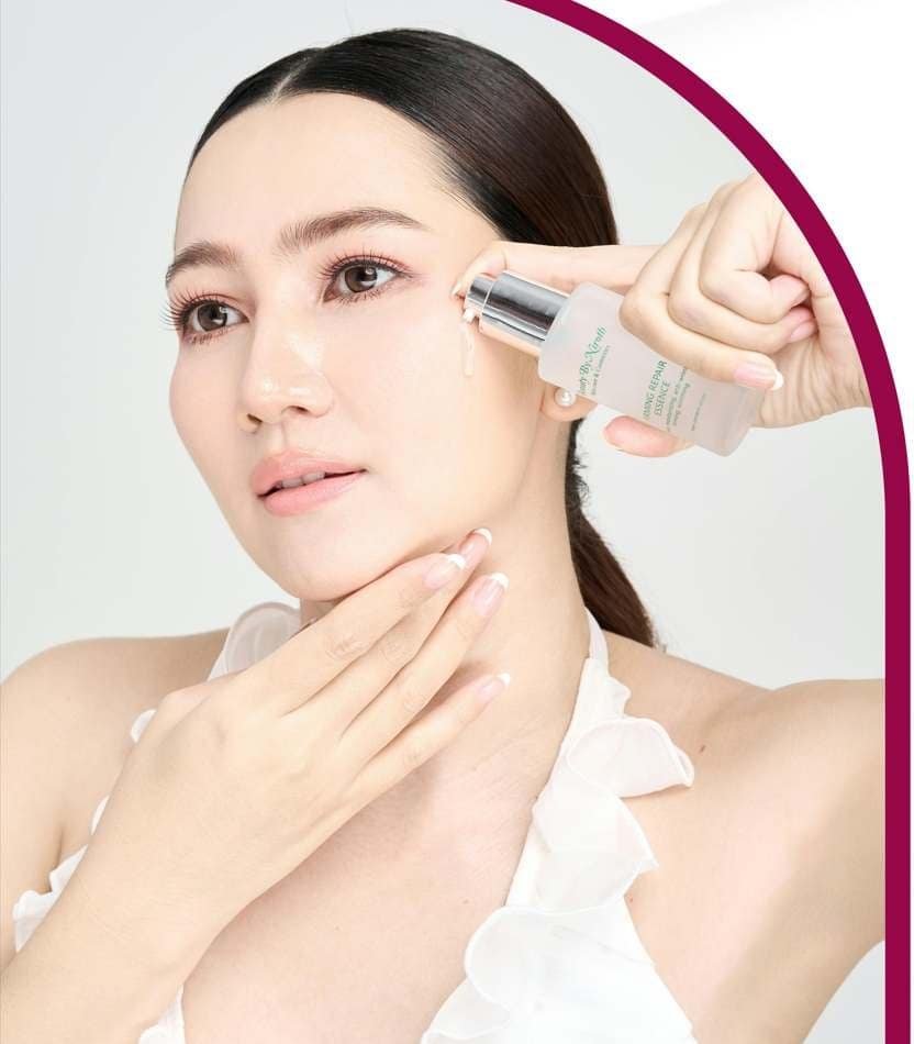 women holding serum on to her face